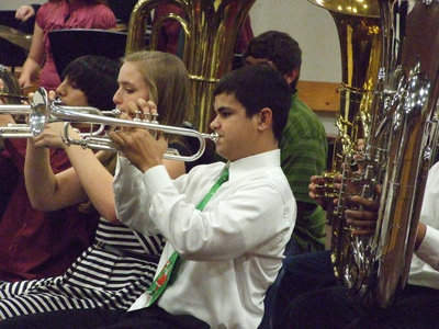 Image: Adam Michael, Madison Washington and Reid Jacinto play their trumpets in the concert.