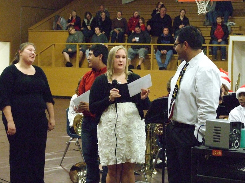 Image: Drenda Burke and Cruz Enriquez with the IHS Gladiator Band present Mr. Perez and Ms. Miller a Christmas gift.