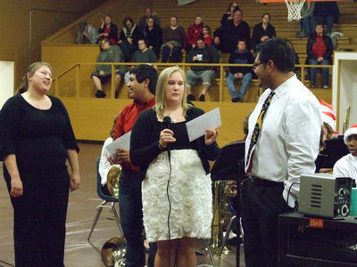 Image: Drenda Burke and Cruz Enriquez with the IHS Gladiator Band present Mr. Perez and Ms. Miller a Christmas gift.