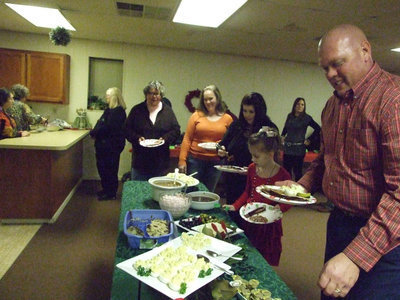 Image: Police Chief Diron Hill led the way to the good food cooked by Karen Mathiowetz and friends.