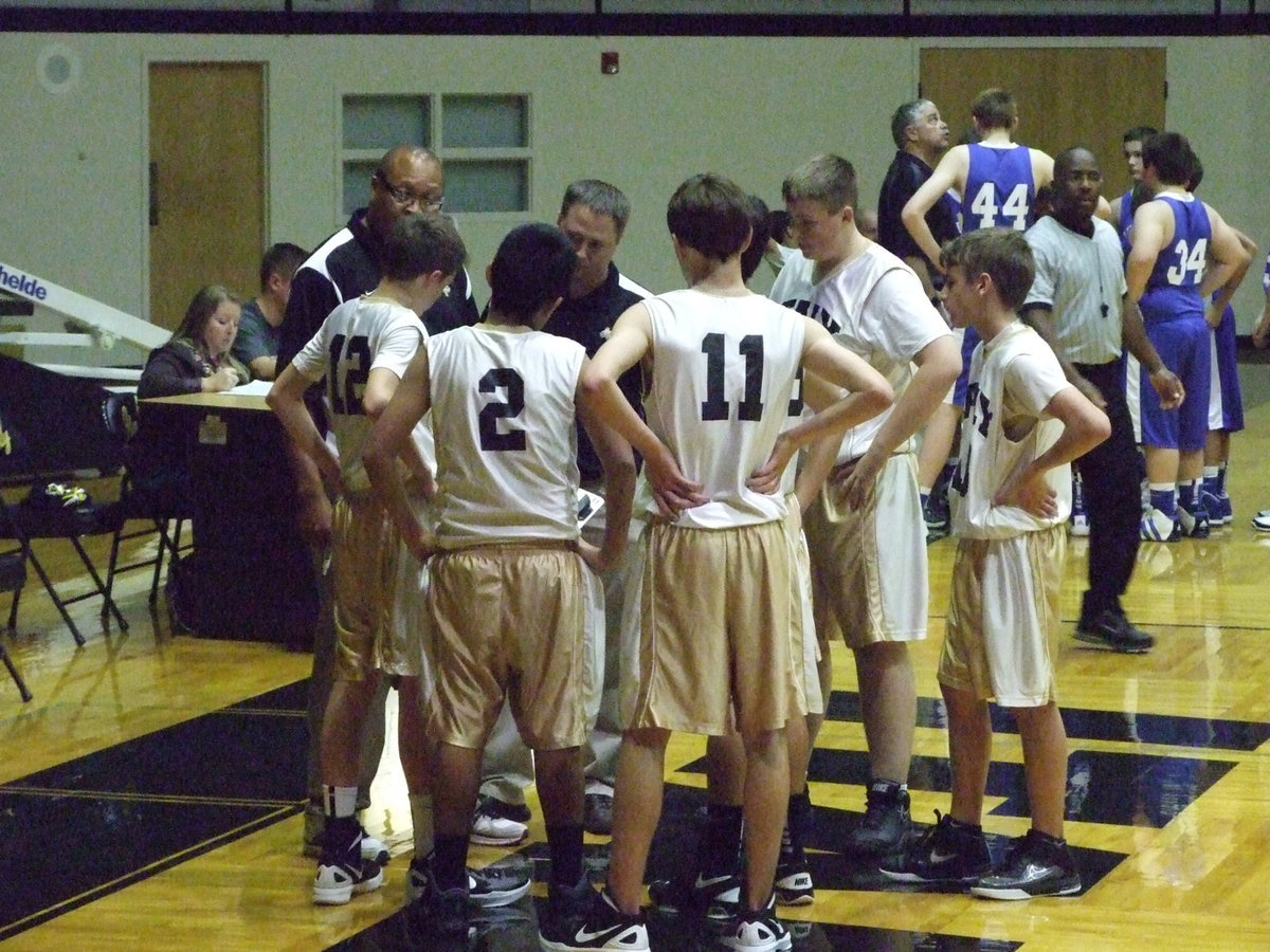 Image: 8th grade Gladiators hear instruction from Coaches Mayberry and Ward.