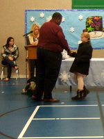 Image: Sydney Lowenthall (fourth grader) shaking hands with Mr. Miller as she accepts her award.