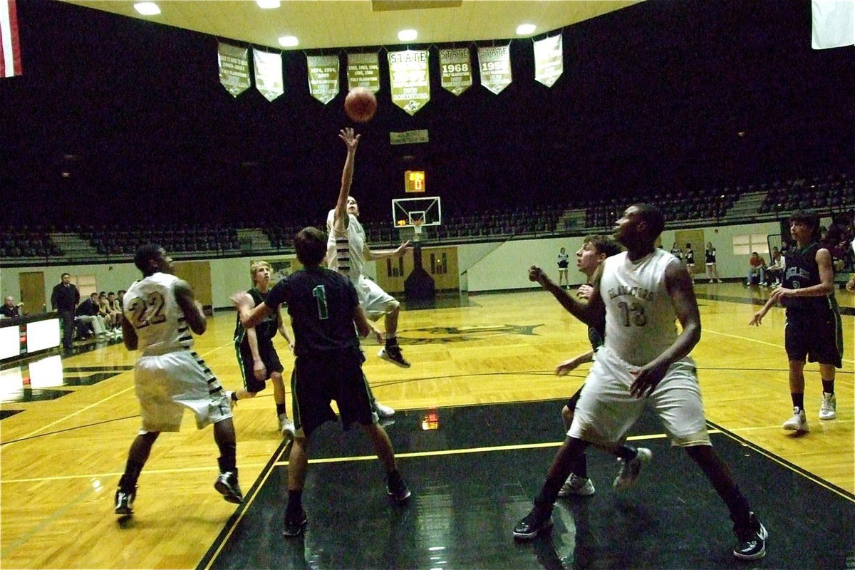 Image: Caden Jacinto(2) lets two of his 14-points fly in over the Rio Vista defense.