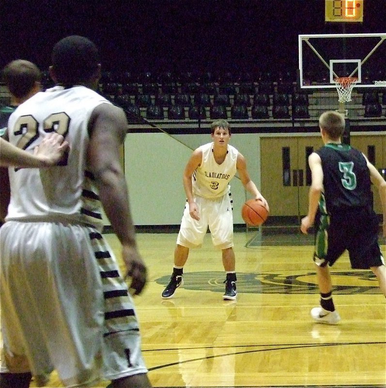 Image: Gladiator point guard Jase Holden(3) takes a look at teammate Jalarnce Lewis(22) who is working the paint.