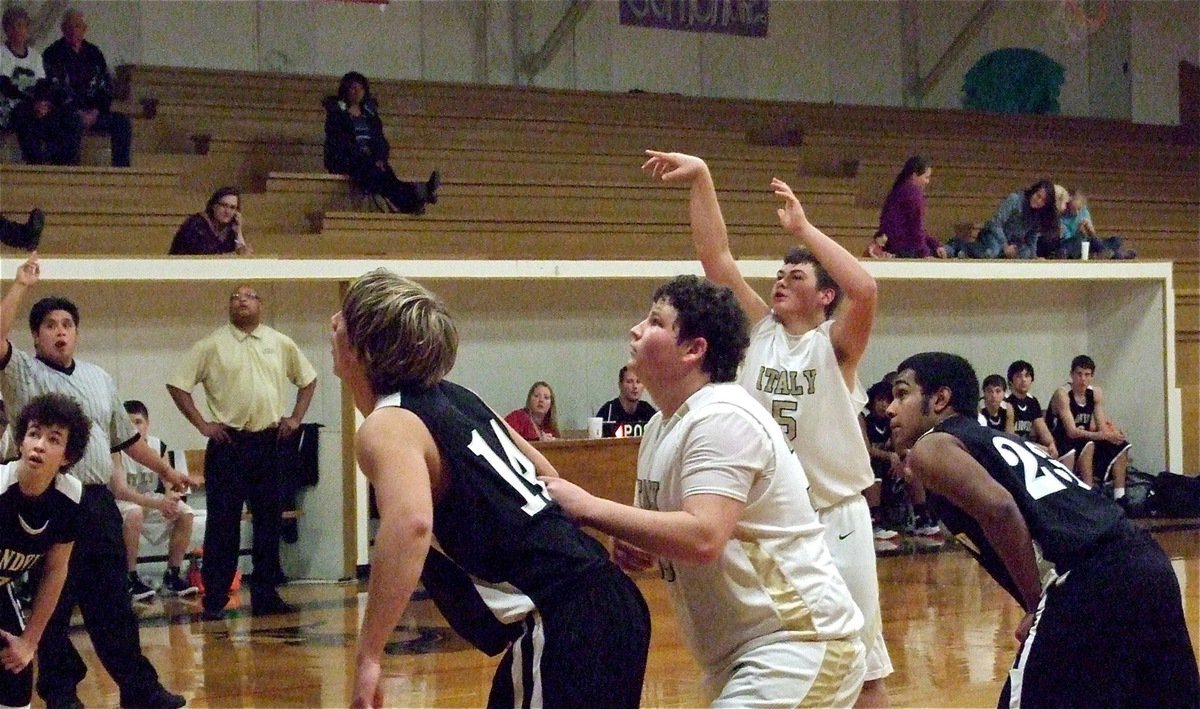 Image: JV Gladiators Zain Byers(5) shoots a free throw with is cousin John Byers(33) ready to rebound.