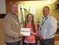 Image: Italy ISD School Board member Mark Stiles presents Kelsey Nelson, a Freshman, her new iPad after Nelson’s name was drawn from a pool of eight potential winners, all of whom earned all A’s during the first semester. 
