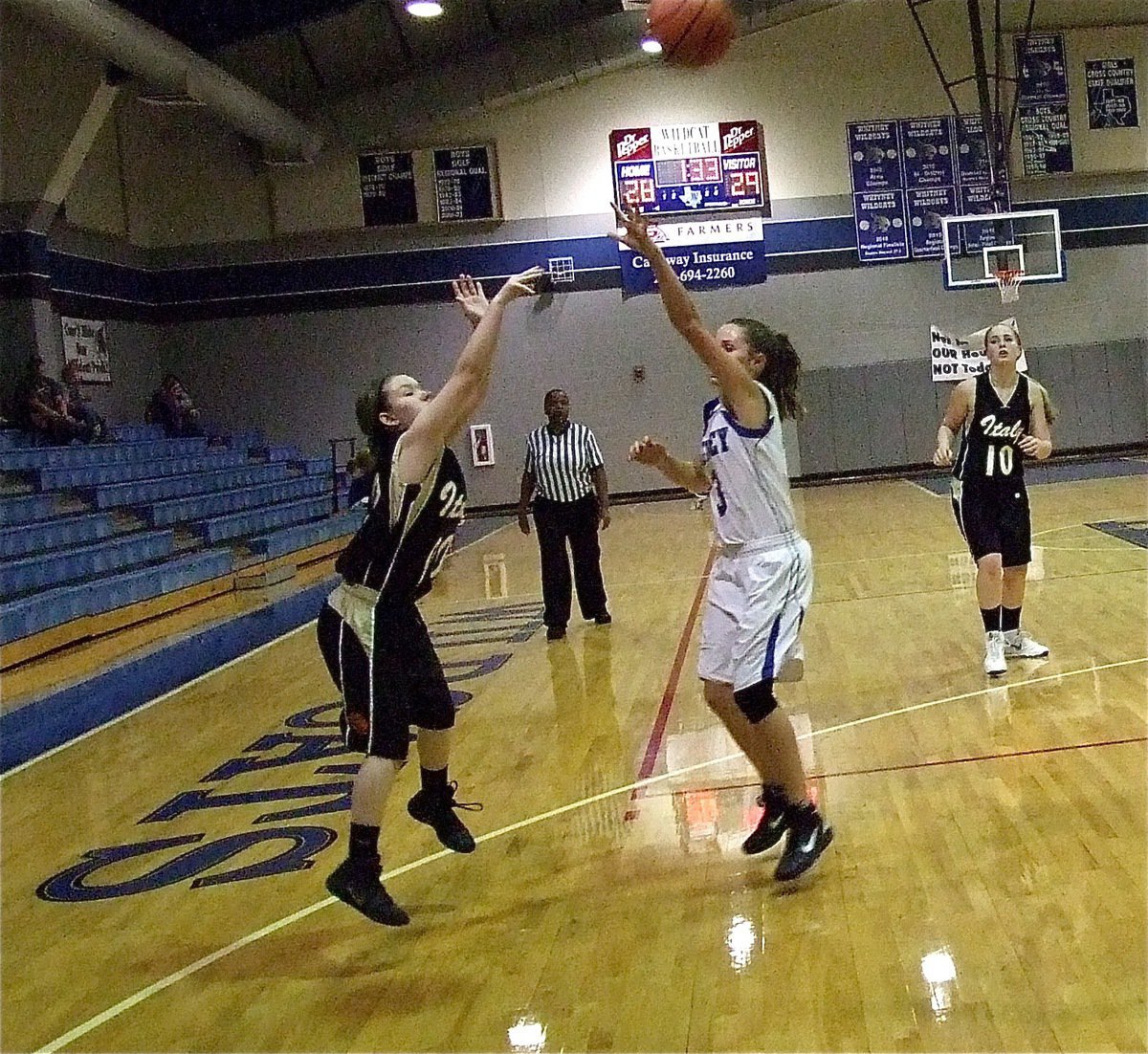 Image: Tara Wallis(00) launches a jump shot over a Whitney defender.