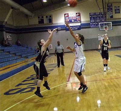 Image: Tara Wallis(00) launches a jump shot over a Whitney defender.