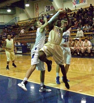 Image: JV Gladiator Tyvion Copeland(4) draws a shooting foul against the Wildcats.