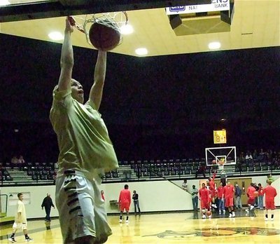 Image: Gladiator Cole Hopkins dunks during warmups before the Axtell game.