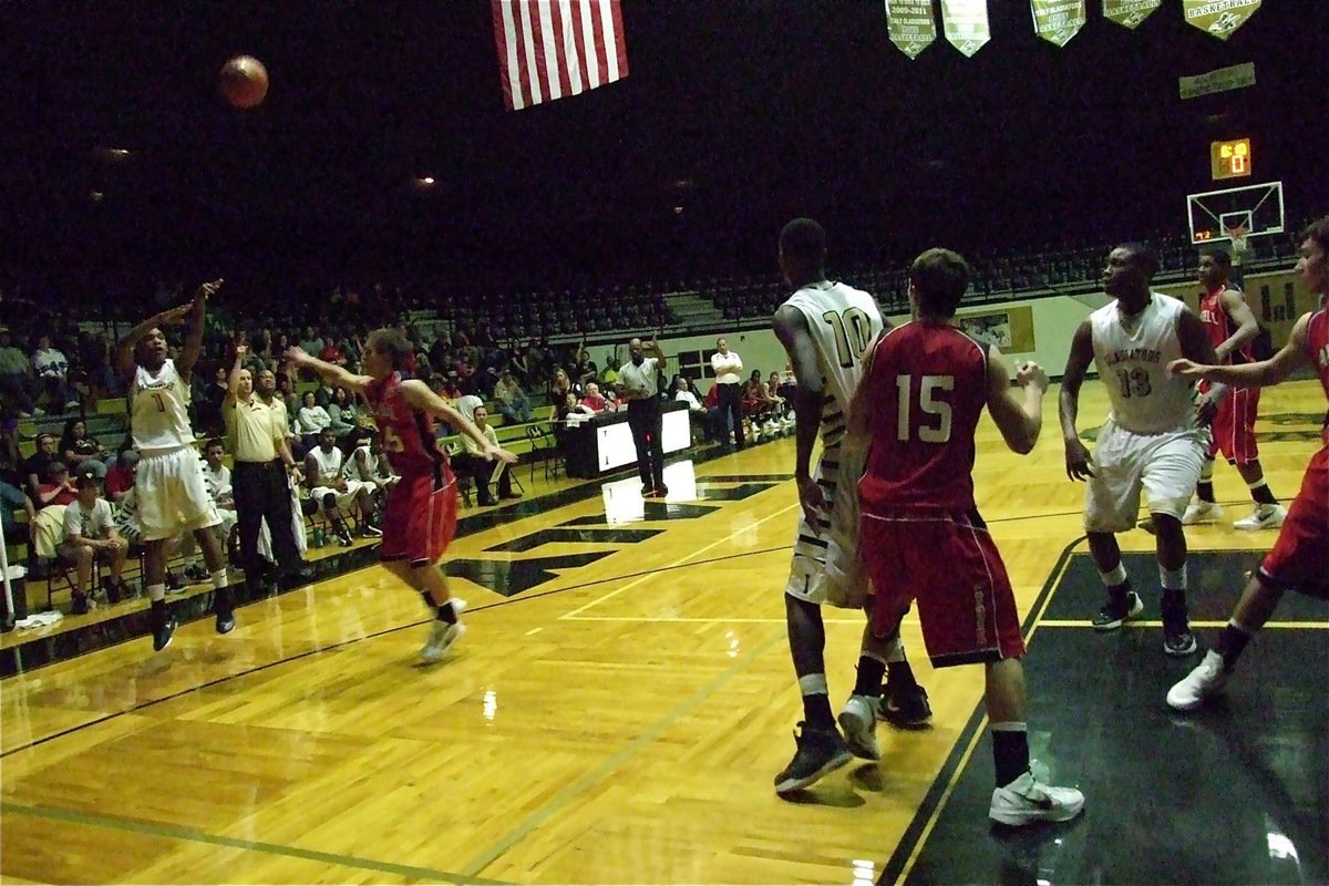 Image: Trevon Robertson(1) puts in one of his five three-pointers against Axtell.