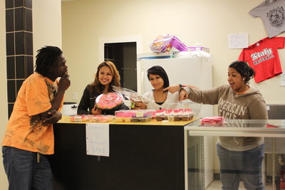 Image: Junior classmates show fellow classmate Ryheem Walker the array of sweets for sale in the concession stand.