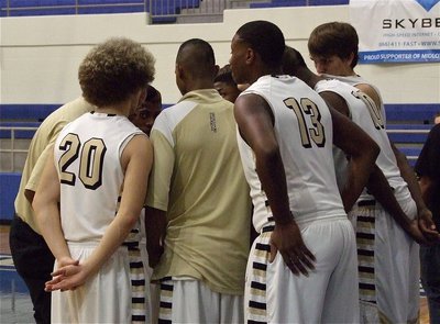 Image: Gladiator assistant coach Larry Mayberry, Sr. huddles the troops moments before the game.