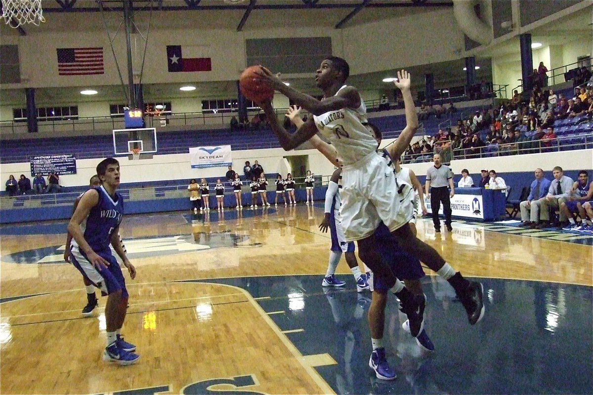 Image: Gladiator senior Devonta Simmons(10) drives the baseline against Whitney.