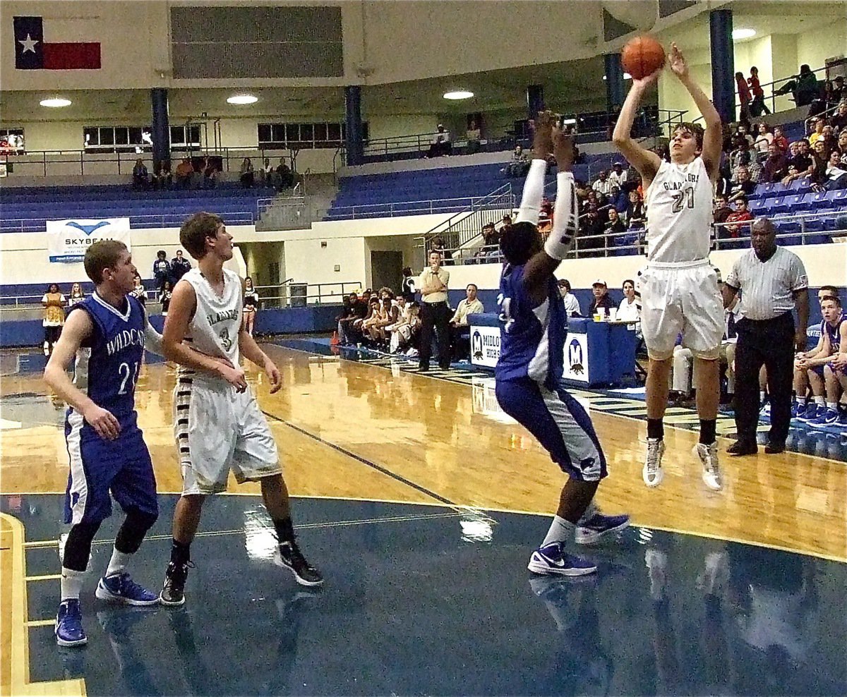 Image: Gladiator junior Cole Hopkins(21) rises high to shoot a jumper.