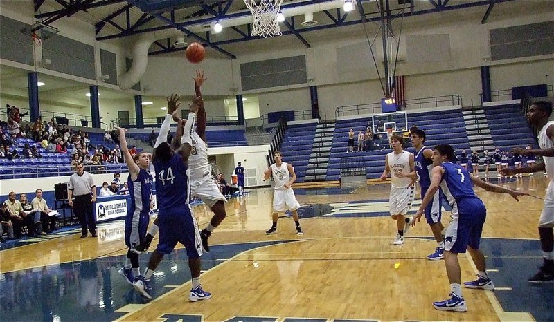 Image: Larry Mayberry, Jr.(13) scores despite Whitney’s best efforts.