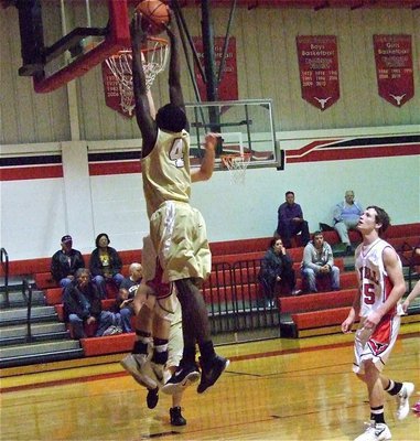 Image: Going for the slam during Italy’s JV game against Axtell is Tyvion Copeland(4).