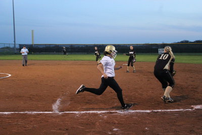 Image: Alma Suaste makes it to first base. 