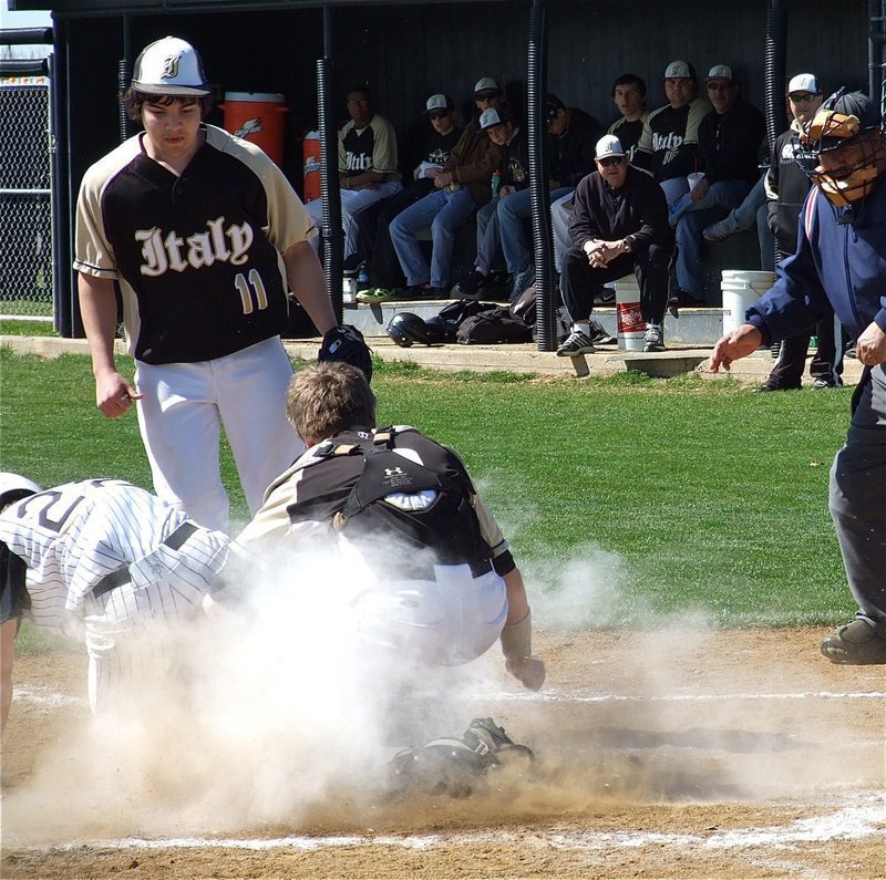 Image: Play at the plate! Italy pitcher Tyler Anderson(11) awaits the call from the umpire after catcher John Escamilla(3) blocks the plate…“Out!”