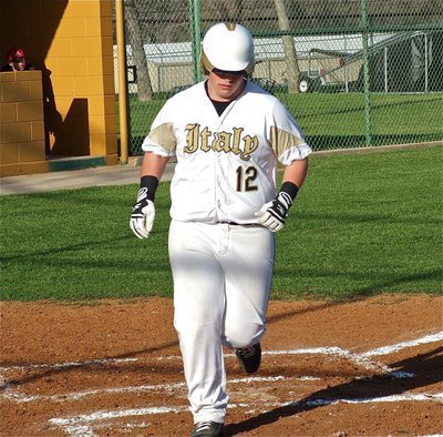Image: John “Curly” Byers(12) nonchalantly crosses home plate.