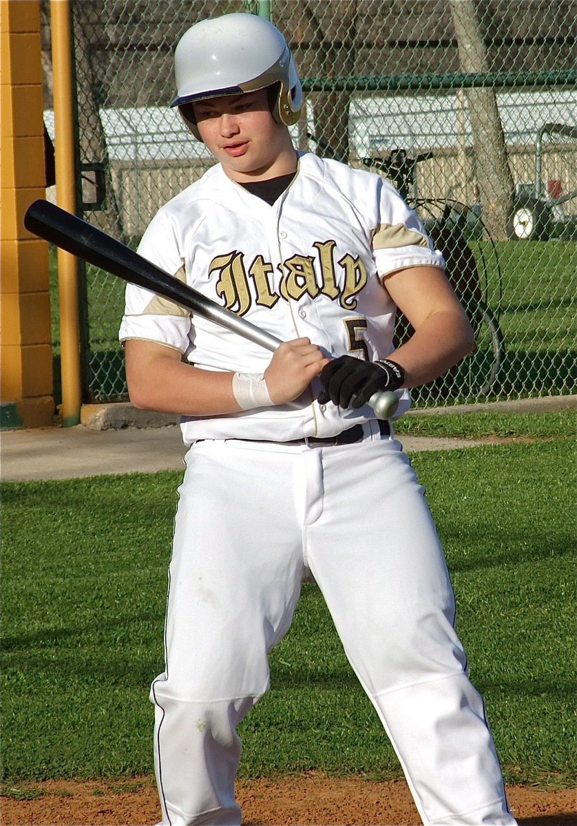 Image: Zain Byers(5) avoids an inside pitch and receives some friendly razzing from his dugout.