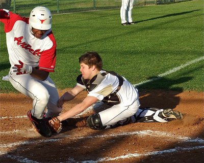 Image: Catcher John Escamilla takes away a sure homerun from Axtell at the last possible instant.