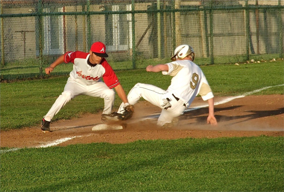 Image: Safe! Cody Boyd(9) slides under the tag at third base.