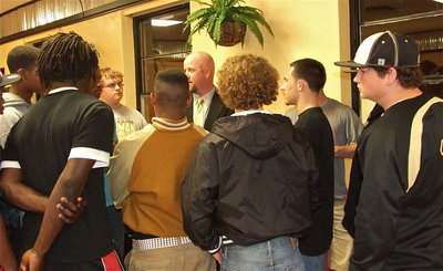 Image: Coach Hollywood addresses several players after the school board meeting closed which made his instatement as the school’s new Gladiator General official.