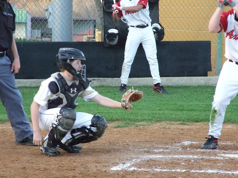 Image: John Escamillia hangs on to the ball.