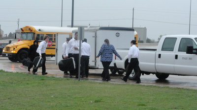 Image: Unloading the instruments in the rain.