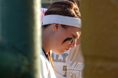 Image: Senior Bailey Bumpus is in deep thought within that tiny void where the fence line ends and the dugout begins.