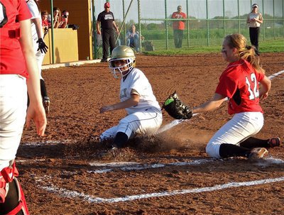 Image: Italy’s Alma Suaste(7) avoids the tag at the plate to score a run for the Lady Gladiators.