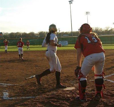 Image: Alyssa Richards stomps on the plate for an Italy run.