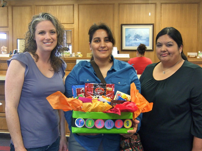 Image: Courney Janek, Tessa South and Nelda Carr (all PTO members) happy to give Italy State Bank this goody basket showing their appreciation for their donation.