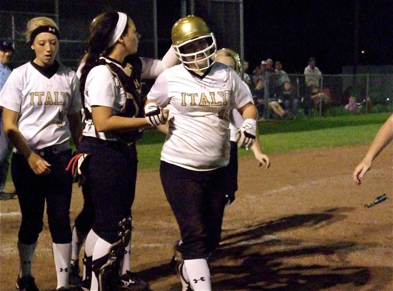 Image: Paige Westbrook(10) gets congratulated by teammate Alyssa Richards(9) after Westbrook blasted her second career over-the-fence homerun beyond the left field fence.