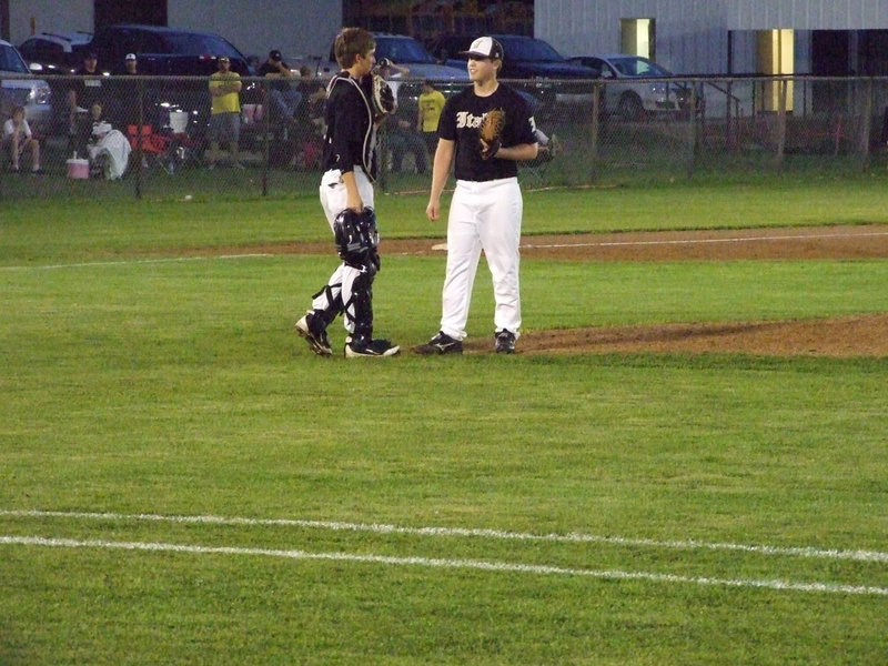 Image: Ross Stiles and Justin Buchanan talk on the mound.