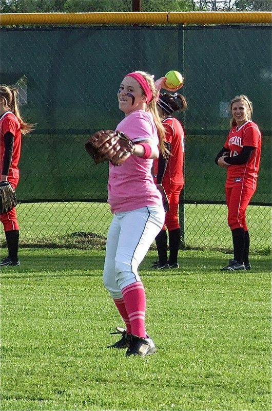 Image: Freshman Lady Gladiator Kelsey Nelson warms up in the outfield.