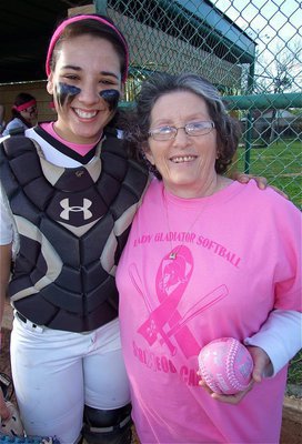 Image: Pretty in pink! Karen Mathiowetz, a 1968 graduate of Italy High School and cancer survivor, tosses the opening-pitch to Lady Gladiator catcher Alyssa Richards. Mathiowetz, who is no stranger to the mound, lofted an underhand pitch directly over the plate to Richards doing her part to “Strikeout Cancer” during Italy’s pink-out game against the Maypearl Lady Panthers.