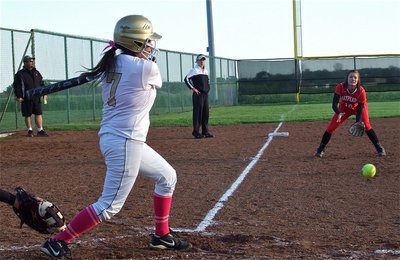Image: Alma Suaste(7) singles for Lady Gladiator head coach Jennifer Reeves who looks on from third base.