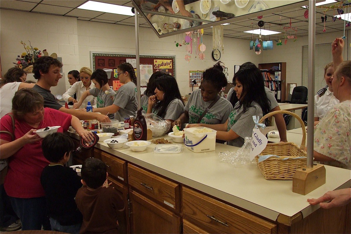 Image: After the performance, cast and crew serve ice cream and snacks to the audience.