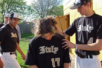 Image: Alex DeMoss(4) takes his turn at trimming the famous fro of, Brandon Souder, as teammate, Omar Estrada, enjoys the ceremonial clipping.
