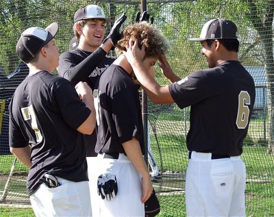 Image: Before their game against Maypearl, Kyle Jackson, Cole Hopkins and Omar Estrada consider possible new looks for Brandon Souder’s upcoming haircut.