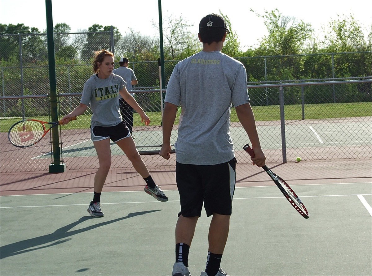 Image: Double Trouble! Bailey Bumpus returns the volley while doubles partner Reid Jacinto stands clear for safety.