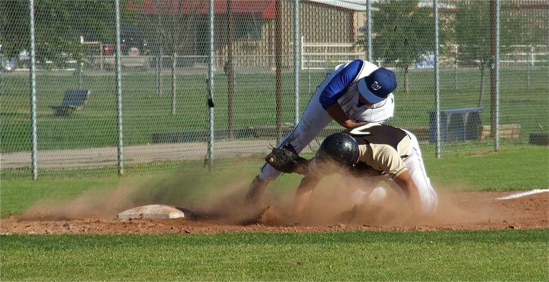 Image: Omar Estrada collides with Whitney’s third baseman while trying to steal third.