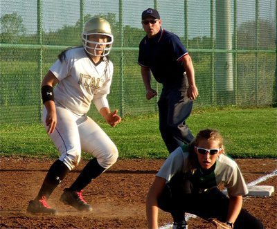 Image: Italy’s Alyssa Richards works the third baseline hoping to steal home.