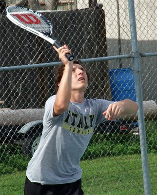Image: Chace McGinnis serves during a men’s singles match.