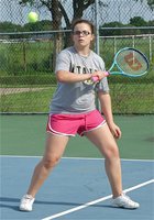 Image: Reagan Adams delivers an effective backhand shot to her opponent.