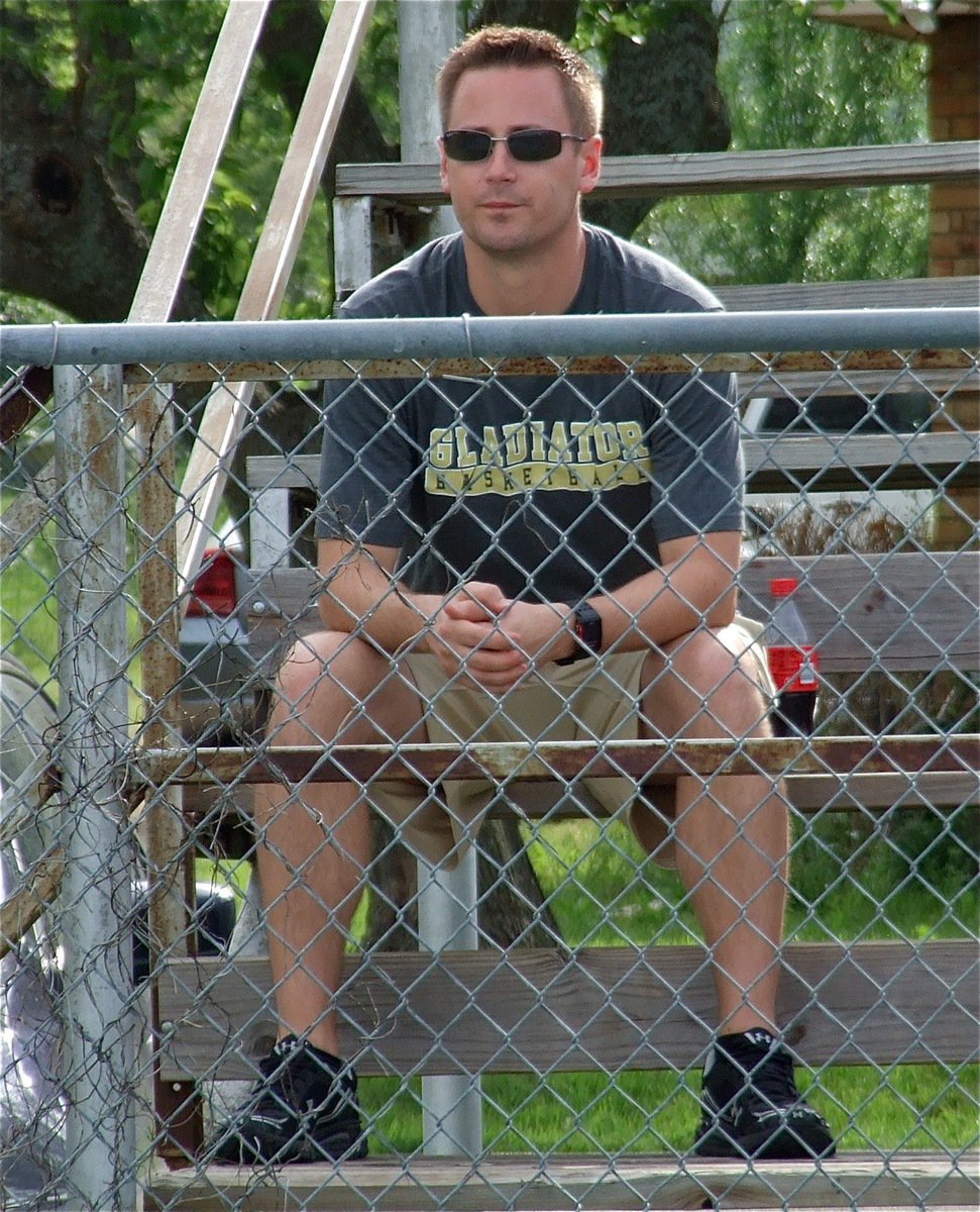 Image: Italy Tennis coach, Aidan Callahan, observes the action on the court from the bleachers.