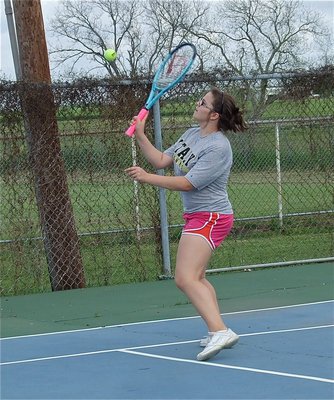 Image: Still volleying, Reagan Adams, keeps the match moving. She promises the light pole was already leaning before she stepped on the court.