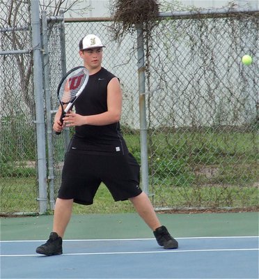 Image: Zain Byers works on his game during a singles matchup, staying wide to keep most of the returns to his forehand side.